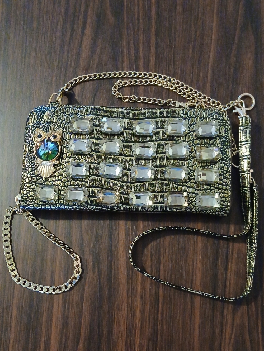 Gold and Black Jeweled Croc-Embossed Wristlet Clutch .